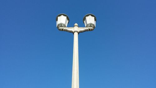 Low angle view of street light against clear blue sky