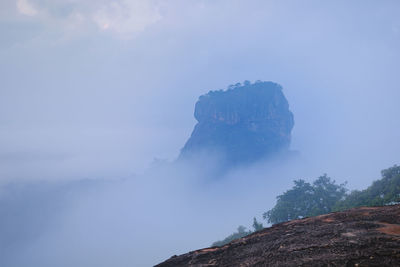 Low angle view of rock formation against sky