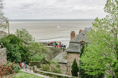 High angle view of trees by sea against sky
