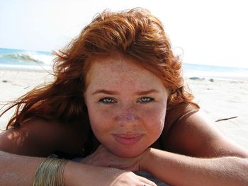 Portrait of young woman sitting at beach