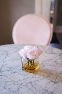 Close-up of pink rose on table