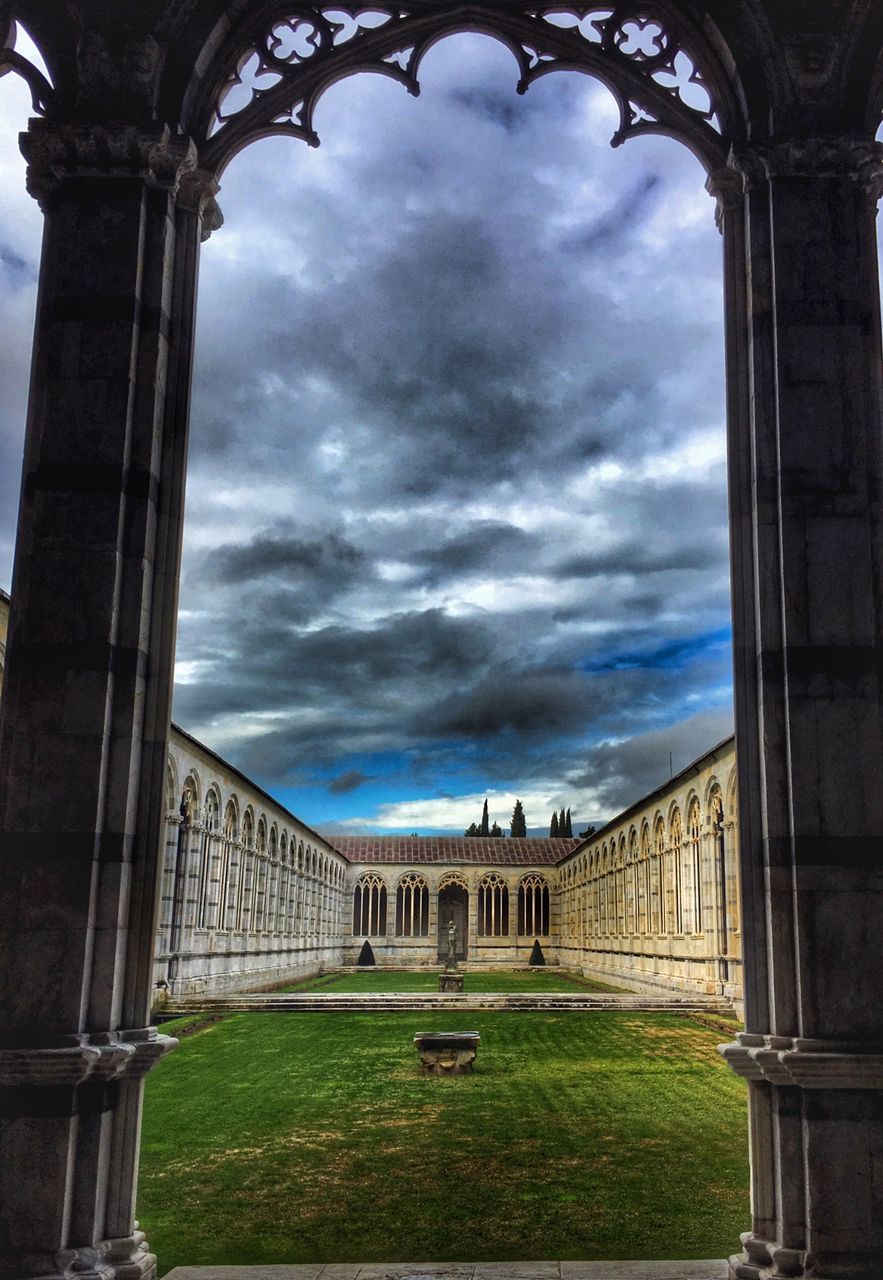 architecture, built structure, sky, cloud - sky, arch, cloudy, architectural column, building exterior, grass, history, cloud, column, travel destinations, famous place, day, the past, low angle view, no people, tourism, outdoors