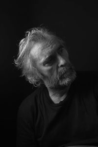 Portrait of man against black background