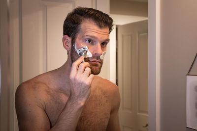 Portrait of young man holding camera