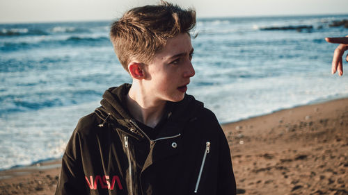 Portrait of boy standing on beach