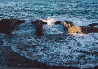 Sea waves splashing on rocks