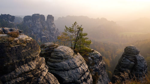 Scenic view of rock formations during foggy weather