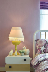 Close-up of electric lamp on table at home