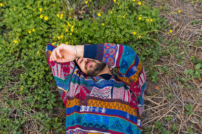 Moroccan man laying on the ground with his hand over his face