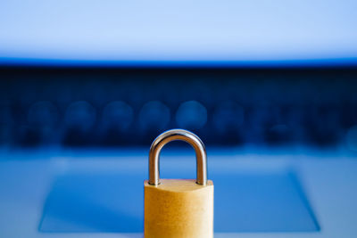 Close-up of padlock on laptop at table