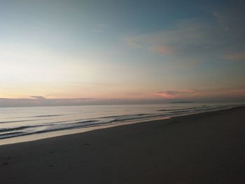 Scenic view of beach against sky during sunset