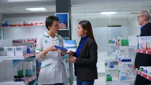 Portrait of female dentist explaining in laboratory