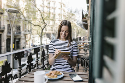 Young woman sitting at table in restaurant