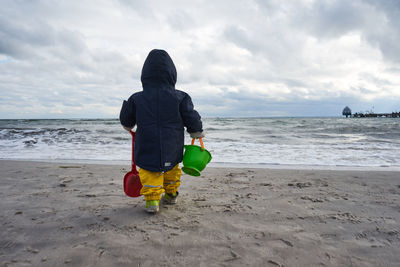 Rear view of boy on beach