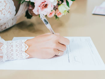 High angle view of woman hand holding paper