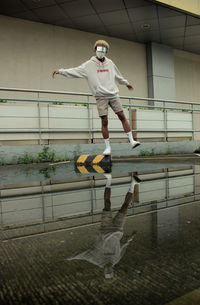 Full length of man jumping on railing