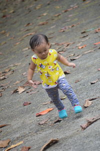 High angle view of girl playing on ground