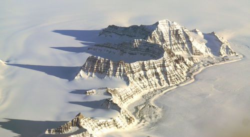 Aerial view of snow covered mountain against sky