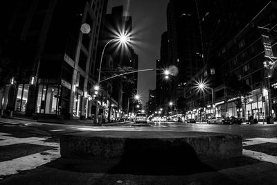 Illuminated city street at night