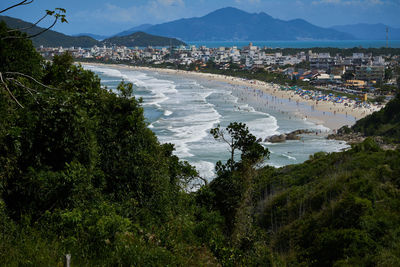 High angle view of sea and mountains against sky