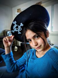 Portrait of girl wearing pirate hat at home