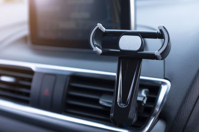 Close-up of smart phone holder on dashboard in car