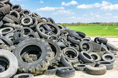 Close-up of tire track on field against sky