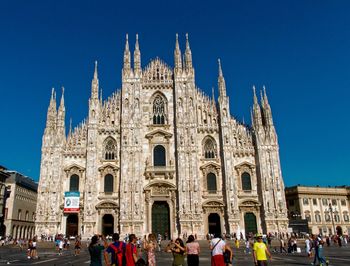 Group of people in front of building against sky