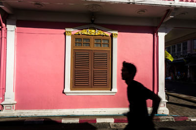 Man looking through window