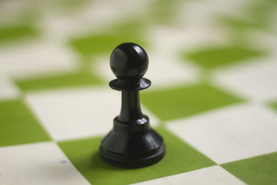Close-up of chess pieces on floor