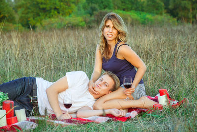 Happy young woman lying on grass