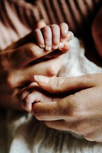 Cropped image of couple holding hands