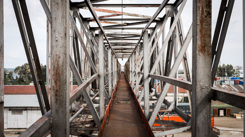 The metal bridge of their structures against the background of a construction 