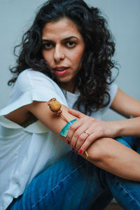 Portrait of beautiful woman holding wilted rose