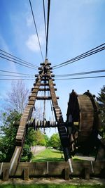 Low angle view of electricity pylon against sky