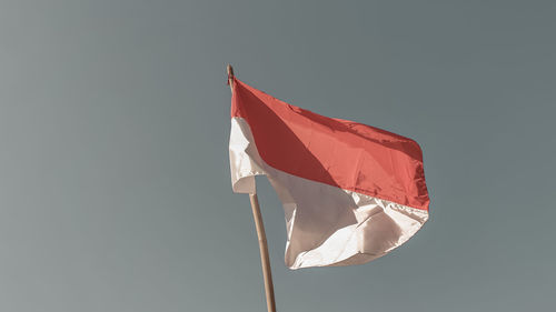 Low angle view of flag against sky