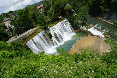 High angle view of waterfall amidst trees