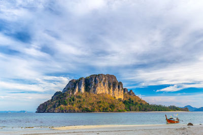 Scenic view of sea and mountains against sky