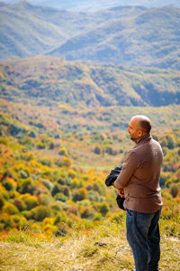 Rear view of man standing on mountain