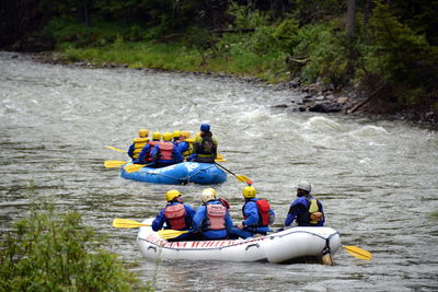 Rear view of people rafting in gallatin river