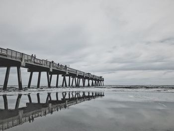 Pier over sea against sky