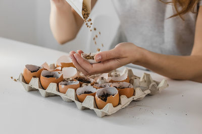 Midsection of woman preparing food on table