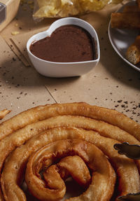 Close-up of thread of batons with cup of chocolate. typical spanish product.