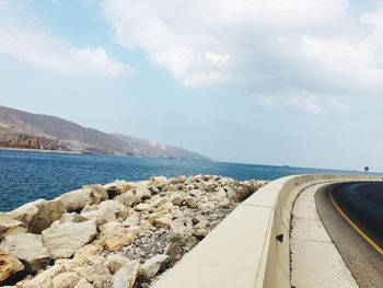 Road by sea against sky