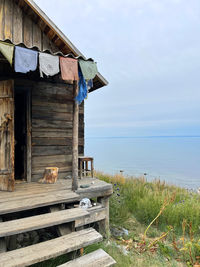 Lonely wooden hut in the taiga on the shore of lake baikal, russia