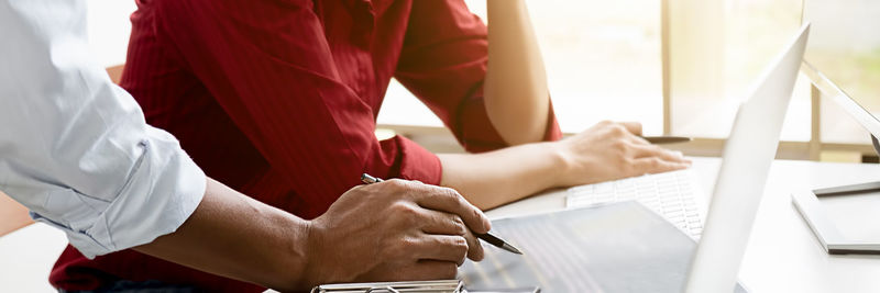 Midsection of man working on table