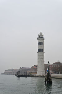 Man standing in front of historical building against sky