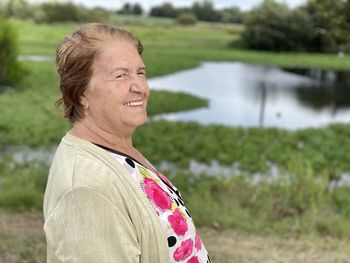 Portrait of smiling woman standing on field