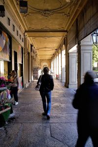 Rear view of woman walking in corridor