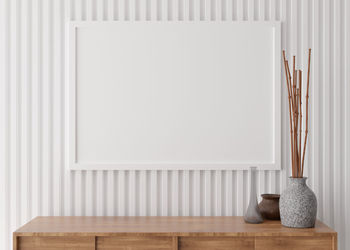 Empty picture frame on white wall in modern living room. mock up interior in minimalist style